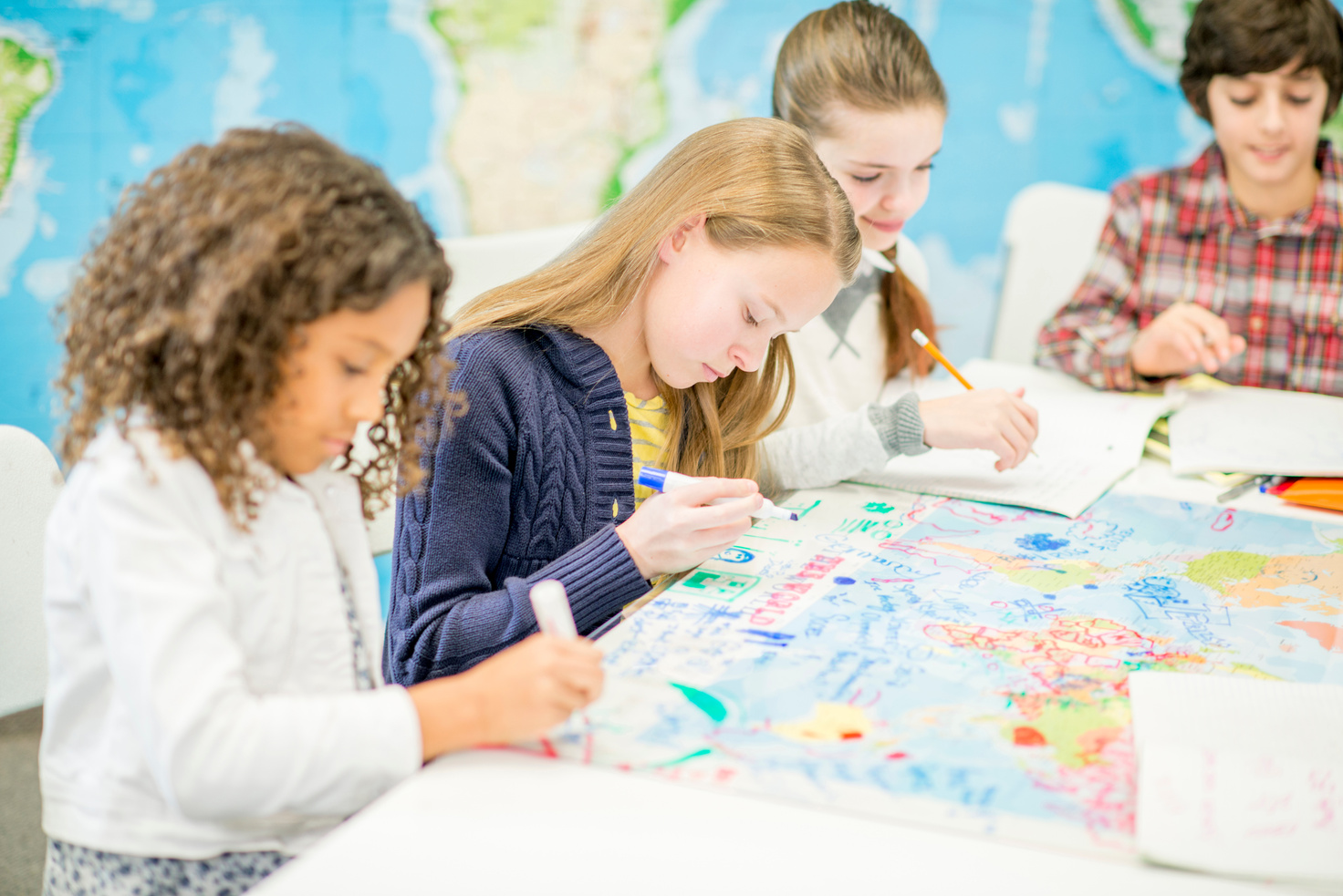 Students Drawing on a World Map